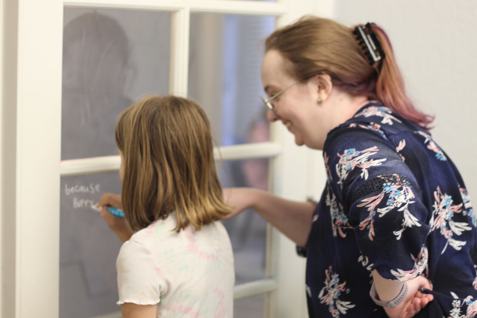 Instructor and student working together at a whiteboard